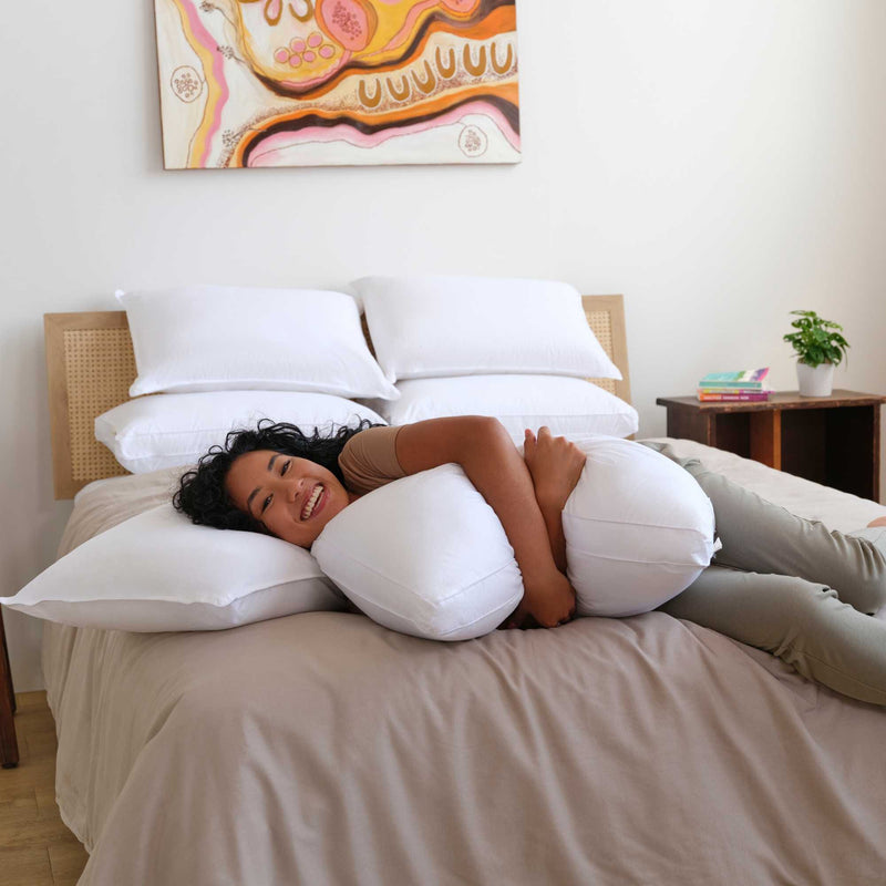 Person laying on pillow bundle